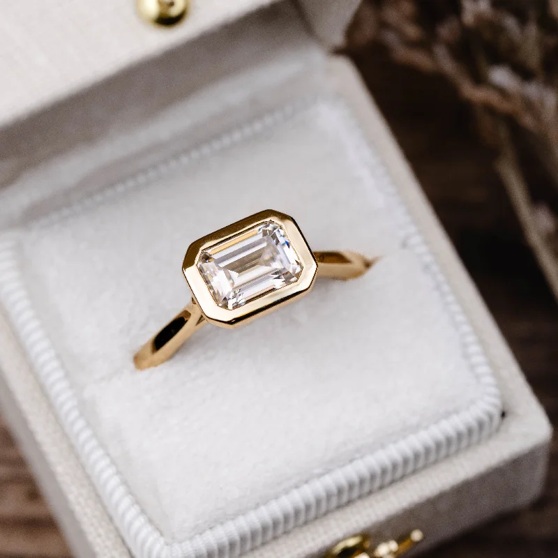 The Adeline - Hidden Halo Emerald Cut Moissanite Engagement Ring with Bezel Setting